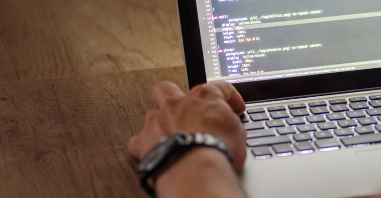 Coding - Person Wearing Black Watch Holding Macbook Pro