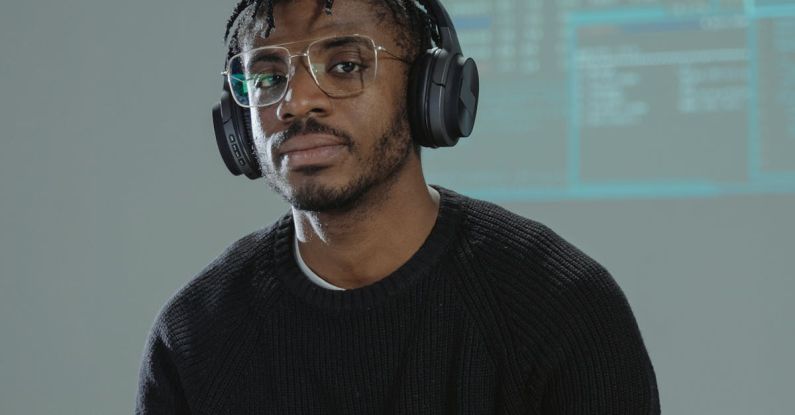 Faker - Man Sitting at Table Wearing Headphones