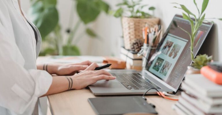 Intervention Image - Woman working retouching photo on laptop at convenient workplace