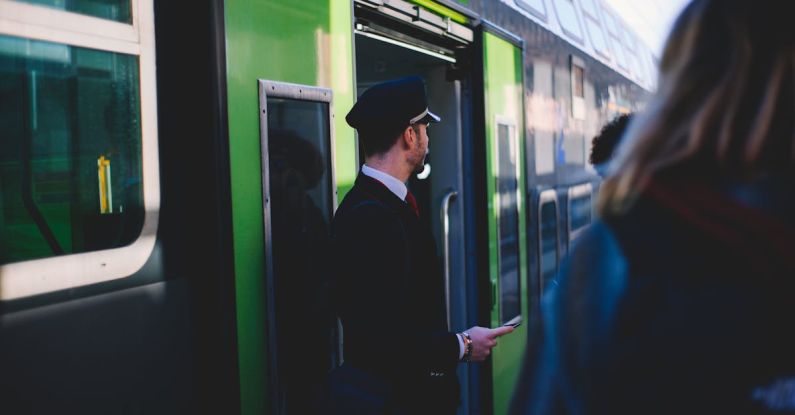 Eloquent ORM - Man in Black Suit Standing Beside Train