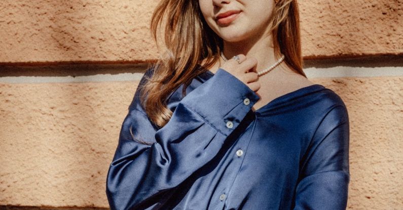 Slim Framework - Young Woman in a Blue Shirt against a Stone Wall