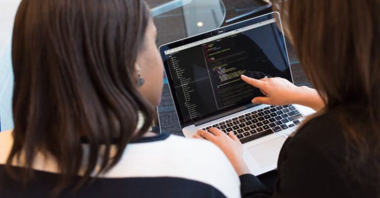 Coding - Two Women Looking at the Code at Laptop