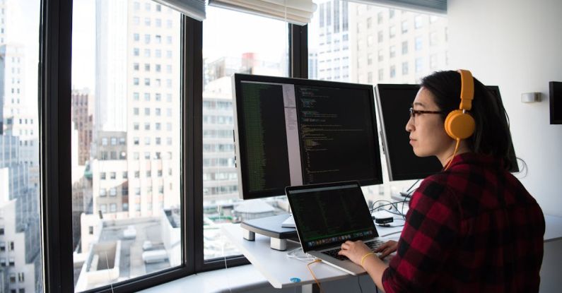 Coding - Woman Sitting While Operating Macbook Pro