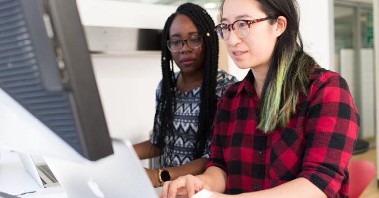 Coding - Woman Wearing Red and Black Checkered Blouse Using Macbook